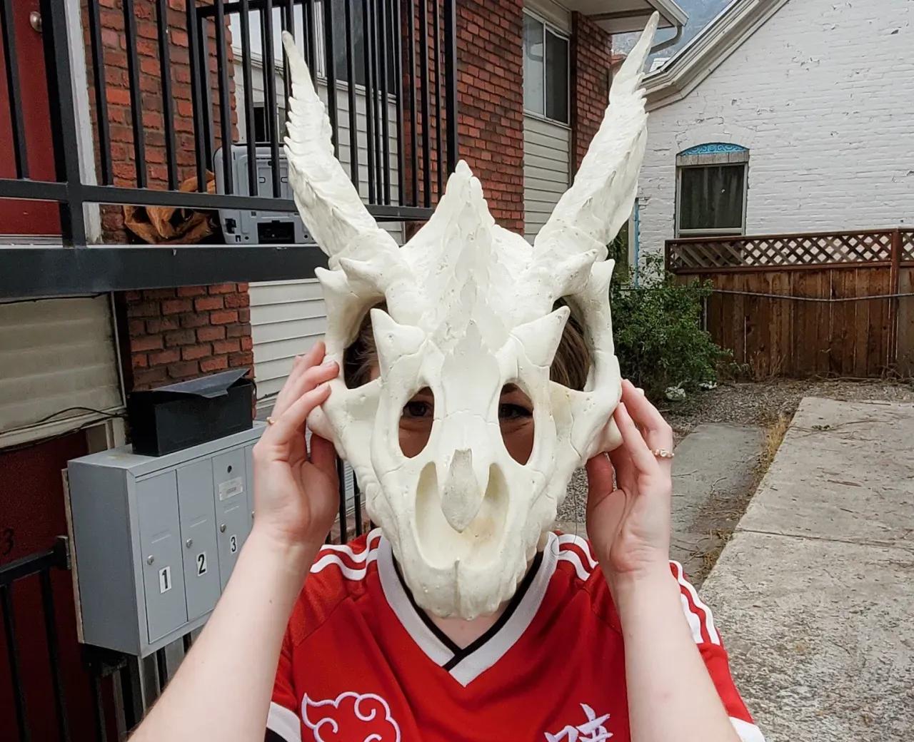 Child holding skull hide