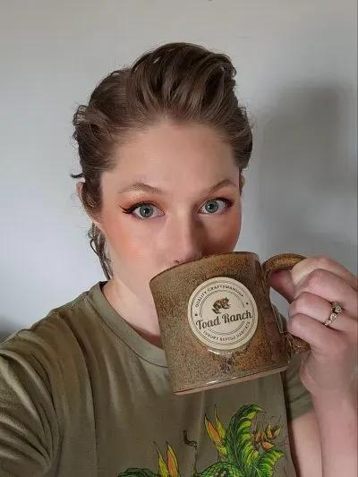 Mariah drinking from Toad Ranch mug